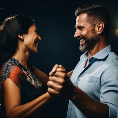 a man and woman dancing in a dark room