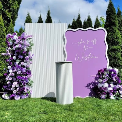 Gradualtion party with a purple and white floral theme