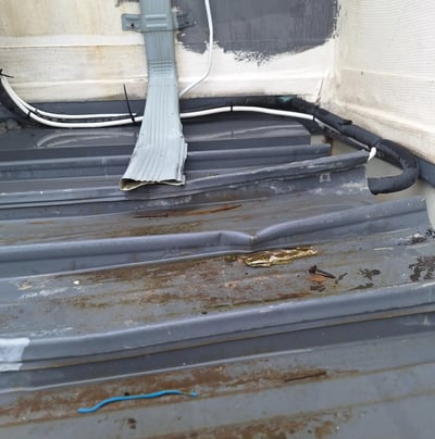 Overflowing roof gutter with poor drainage