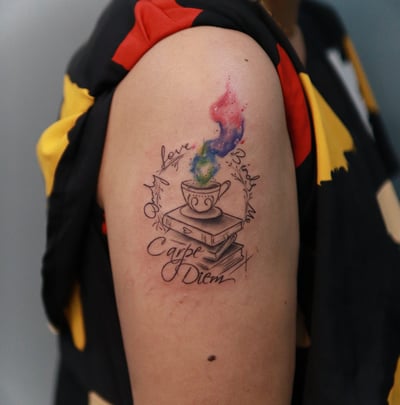 Watercolor coffee cup design with books tattoo at Dudo's Tattoos Hyderabad
