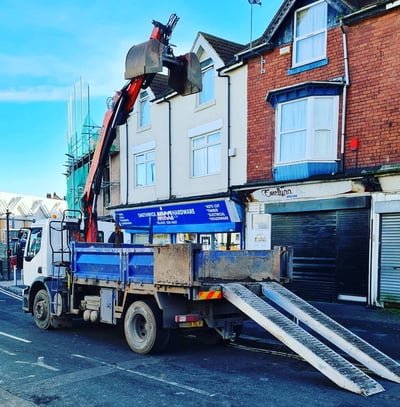 grabber lorry outside a row of shops in birmingham