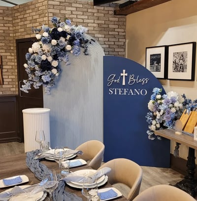 navy blue and baby blue themed baptism with floral arrangements