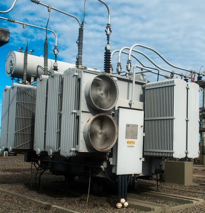 a large group of electrical equipment sitting on top of a field