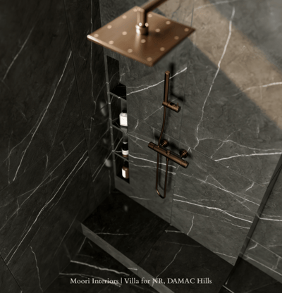 Luxurious shower detail featuring black marble shower walls with white veining and bronze fixtures