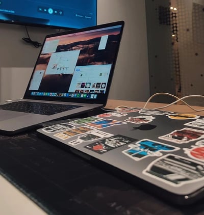 a laptop computer sitting on a table with a laptop and a monitor