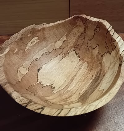 Turned spalted beech bowl with rough cleaved edge