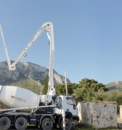 a cement mixer truck with a man standing next to it