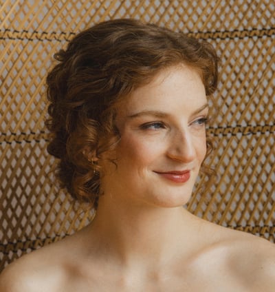 Bride smiling and gazing into the distance.