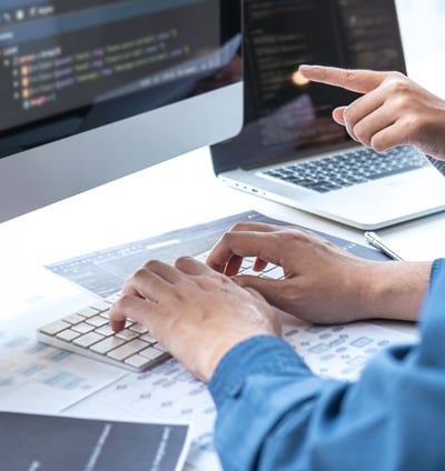 Two people developing custom software solutions for business automation and increased efficiency