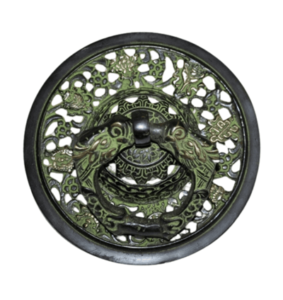 a decorative metal plate with a green dragonfly