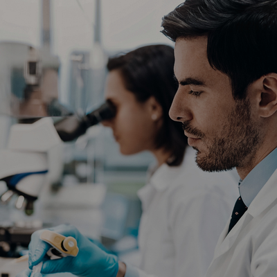a man and woman in lab coats and gloves