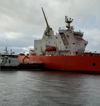 a large red ship in the water