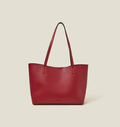 a red leather tote bag with a red and black tote bag