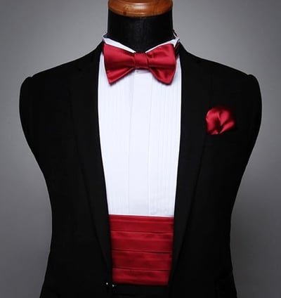a man in a tuxedo suit and bow tie