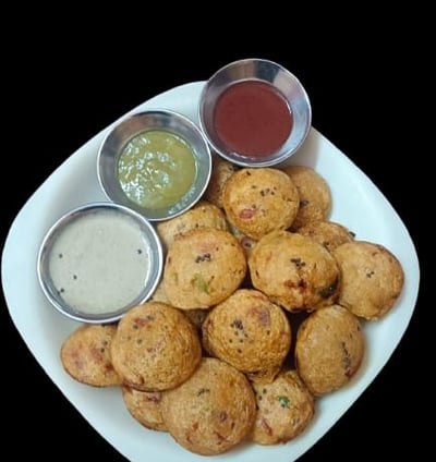 alt="Healthy Appes or Paniyaram served with coconut, spicy, and sweet sauces on a white plate"