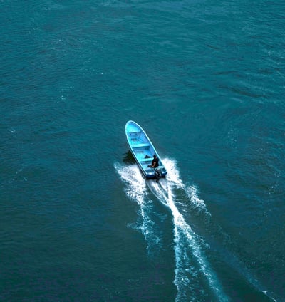 a boat with a blue and white boat in the water