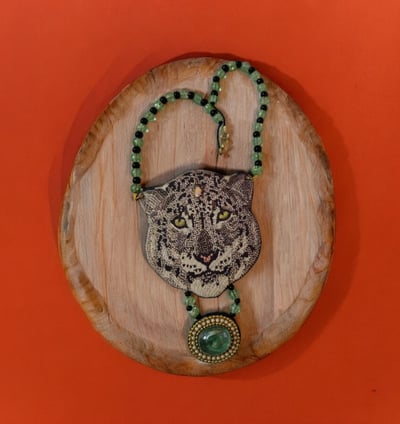 a leopard head with a necklace with a leopard head