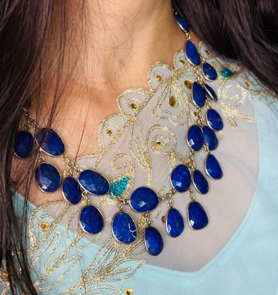 a woman wearing a Lapis Lazuli Necklace