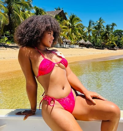 a woman in a pink bikini top and a pink bikini