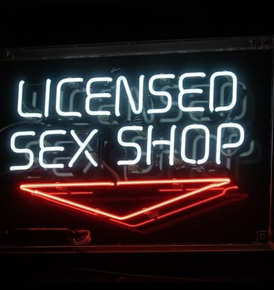 neon sign that reads licensed sex shop