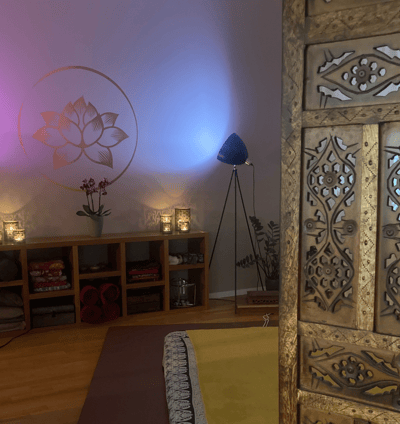 a massage space with a futon on the floor and candles