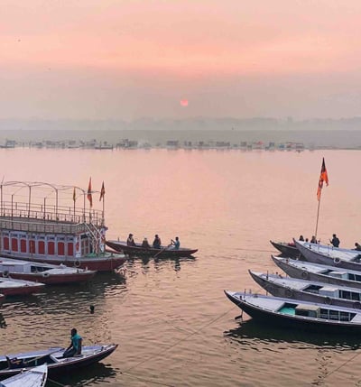 Numerous boats at sunrise on the Ganges River in Varanasi, India.