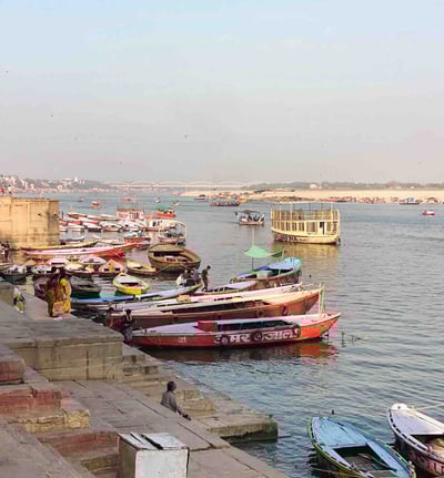 Photo of numerous colorful boats on the Ganges River in Varanasi, India.