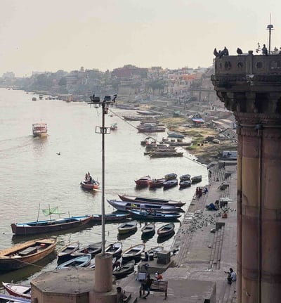 View of the ghats in Varanasi with various boats on the Ganges River