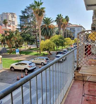 a balcony with a bench and a table with a chair