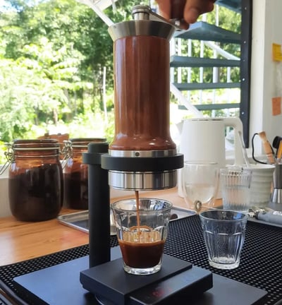 a person is brewing a slow coffee in a manual espresso maker