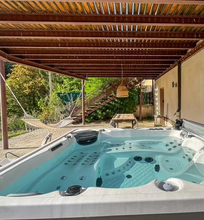 a hot tub tub in a backyard with a wooden deck