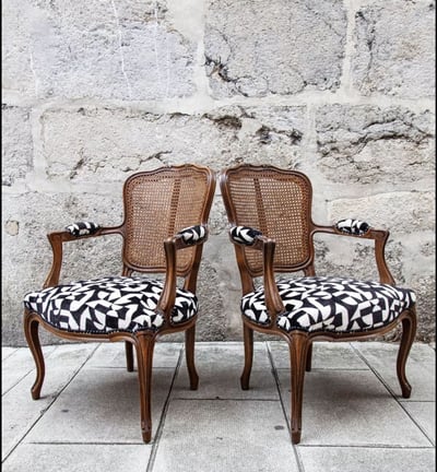 two chairs with a black and white patterned seat