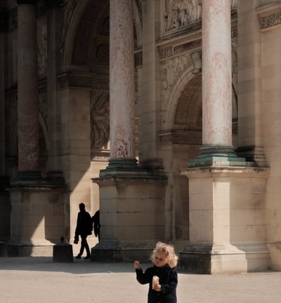 a child is eating almonds at the Louvre in Paris