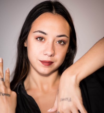 a woman with tattoos on her hands and a tattoo on her hand