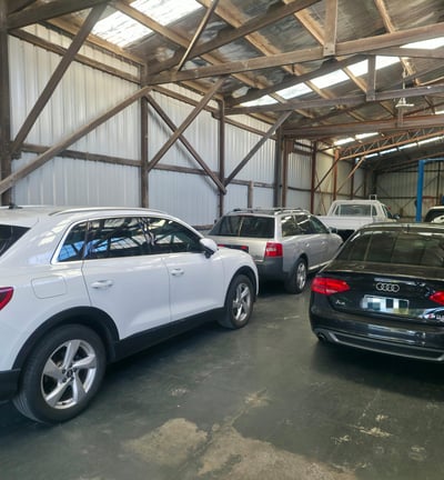 a group of cars parked in a workshop