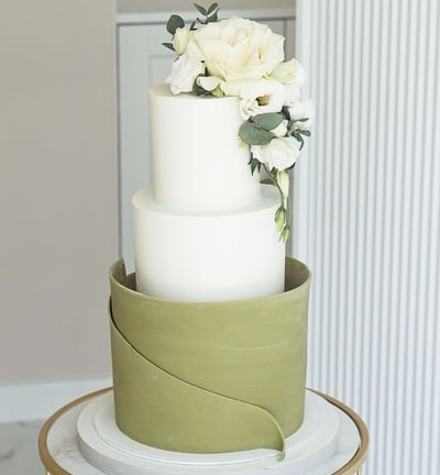 a cake with white flowers on top of a table