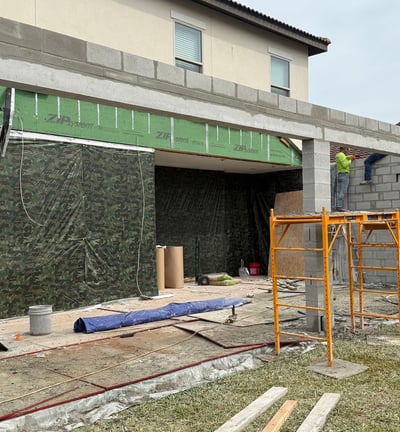 Ongoing porch renovation project featuring concrete slab and custom structural supports by top remod