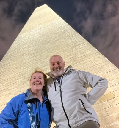 a man and woman standing in front of a monument in Washington DC