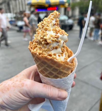 Large Ice Cream in a cone topped with nuts