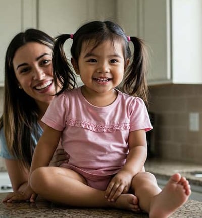 mother with child on cabinet in kitchen
