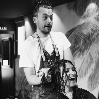 a man dressing someone's hair