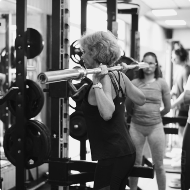 a woman doing a barbell squat