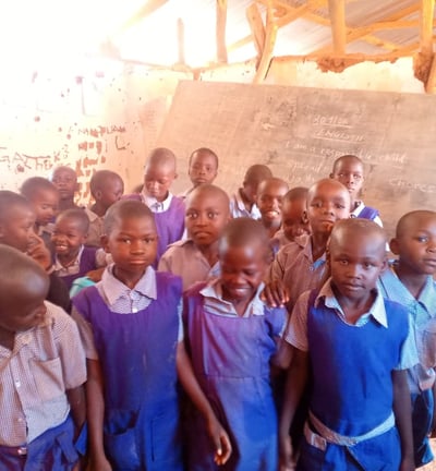 rural African village kids posing to the camera in their class