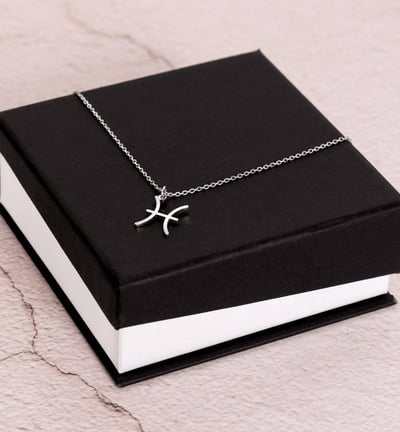 a black box with a silver cross on it