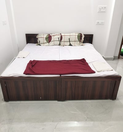 a bed with a red blanket and pillows