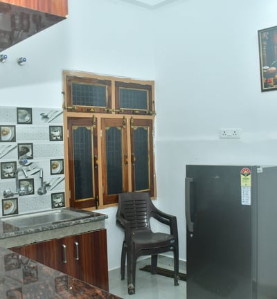 a kitchen and a chair in a room
