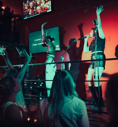 karaoke: a group of people standing on a stage