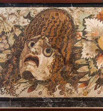 Tragic mask, detail of an ancient roman mosaic. Pompeii, Italy.