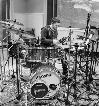 a man playing drums in a recording studio