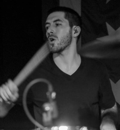 a man playing drums in a band